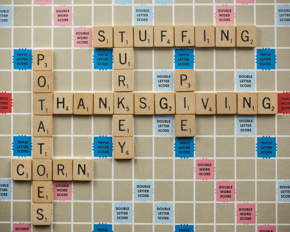 A scrabble board with lettered tiles