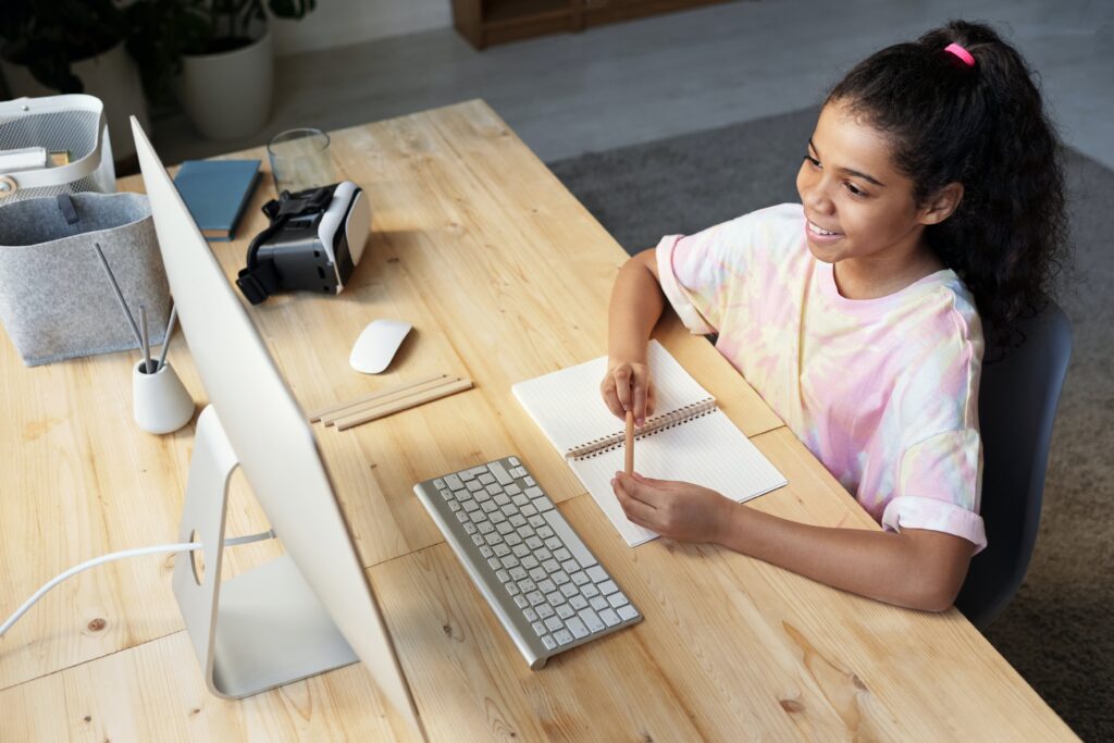 A girl learning on a desktop at her desk