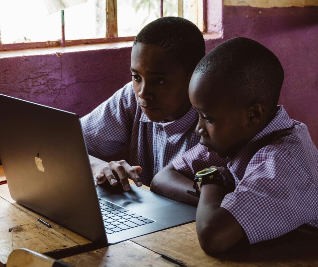 Two students learning from a laptop