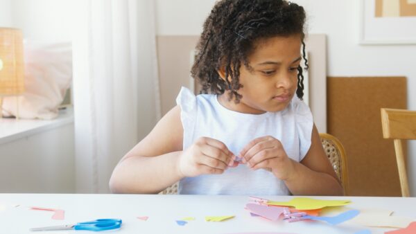 A young girl engaging in craft at a desk