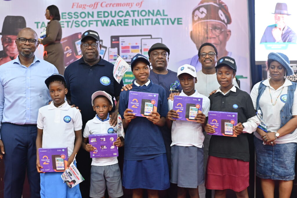 L-R: Sim Shagaya, CEO of uLesson Group; Dr. George Uzonwanne, NDDC Director of Education, Health, and Social Services; and other officials of the NDDC with some beneficiaries of the digital learning project.